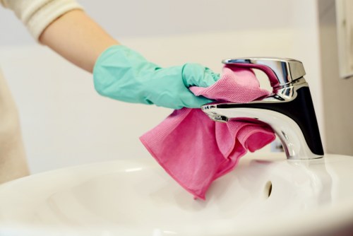 Professional home cleaner in an EC1 apartment living room