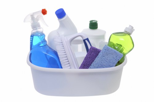 Cleaner sanitising desks during office cleaning in EC1